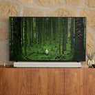 Sonos Arc Soundbar in white on a console table in front of a television