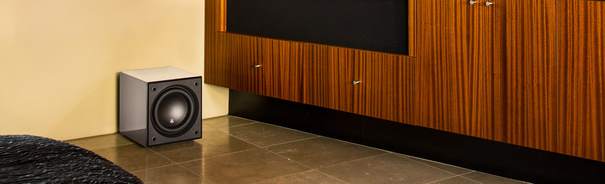 JL Audio Dominion d110 Subwoofer on floor beside a counter